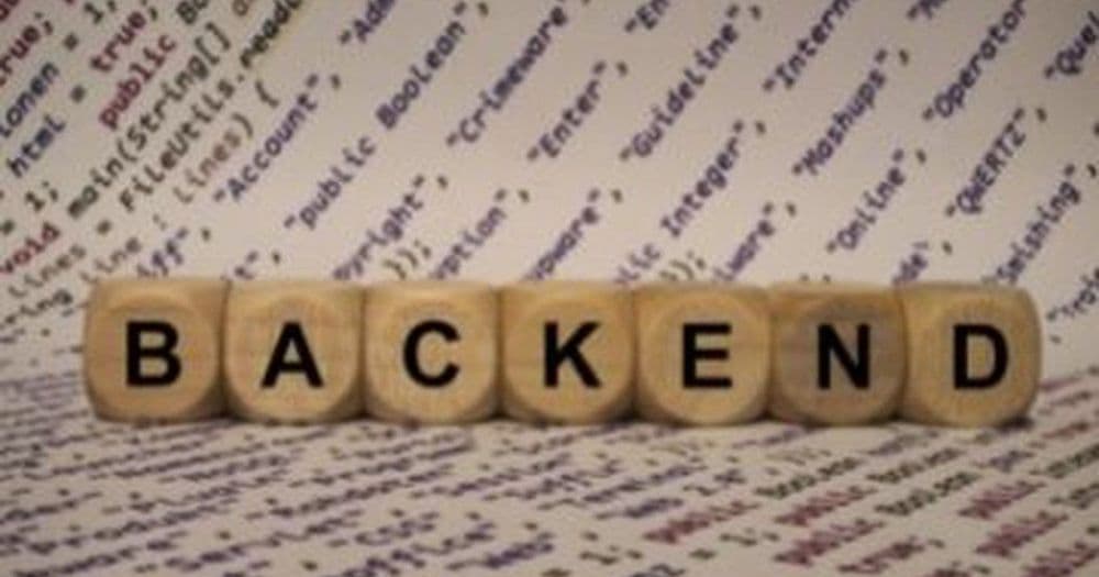 Wooden letter blocks spelling BACKEND over lines of code