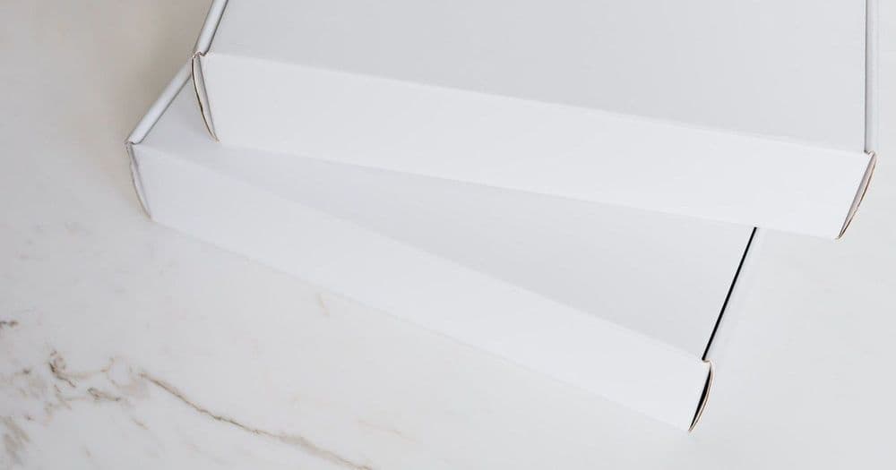 Plain white gift box on a marble surface for corporate gifting